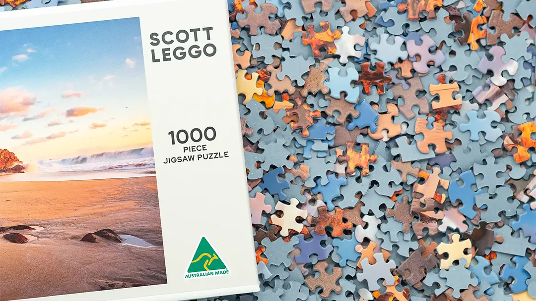 Adult 1000 piece jigsaw puzzle box with pieces.