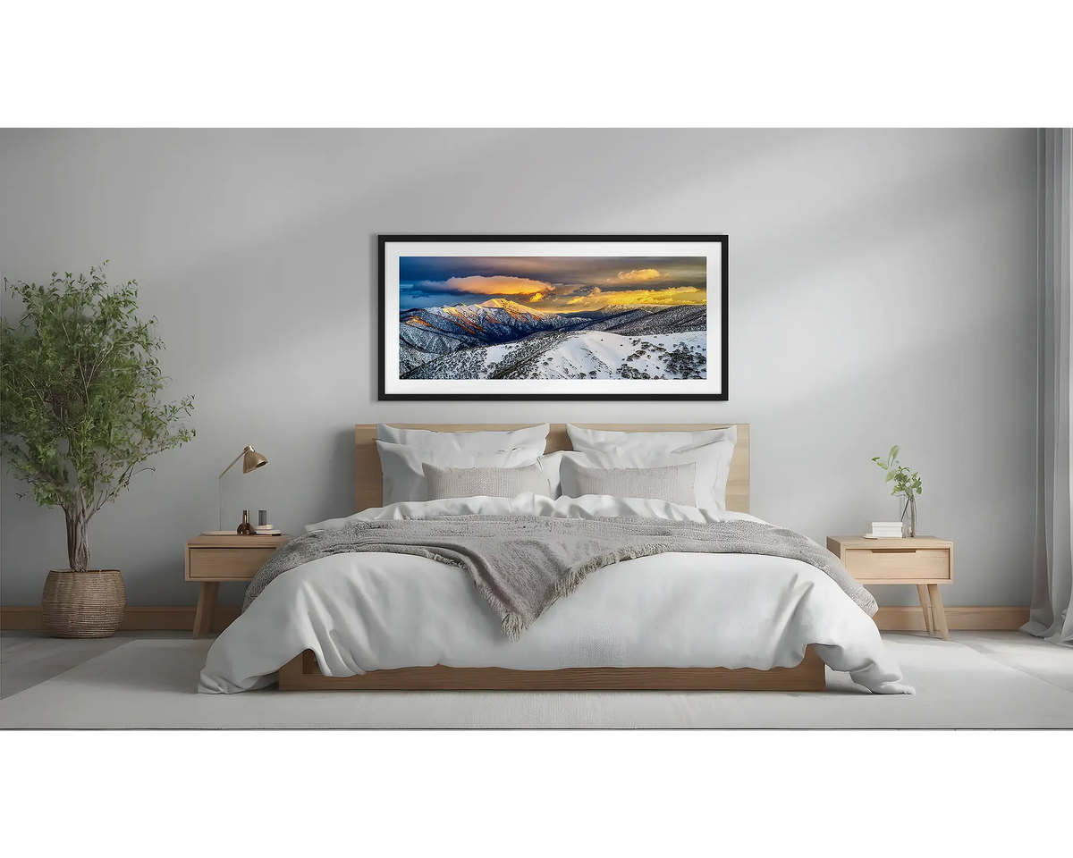 Alpine Magic. Winter snow sunrise wall art  in black frame above a bed.