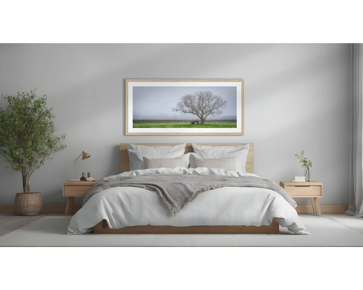 Amongst The Vines. Framed country wall art in a Tasmanian Oak frame, above a bed.