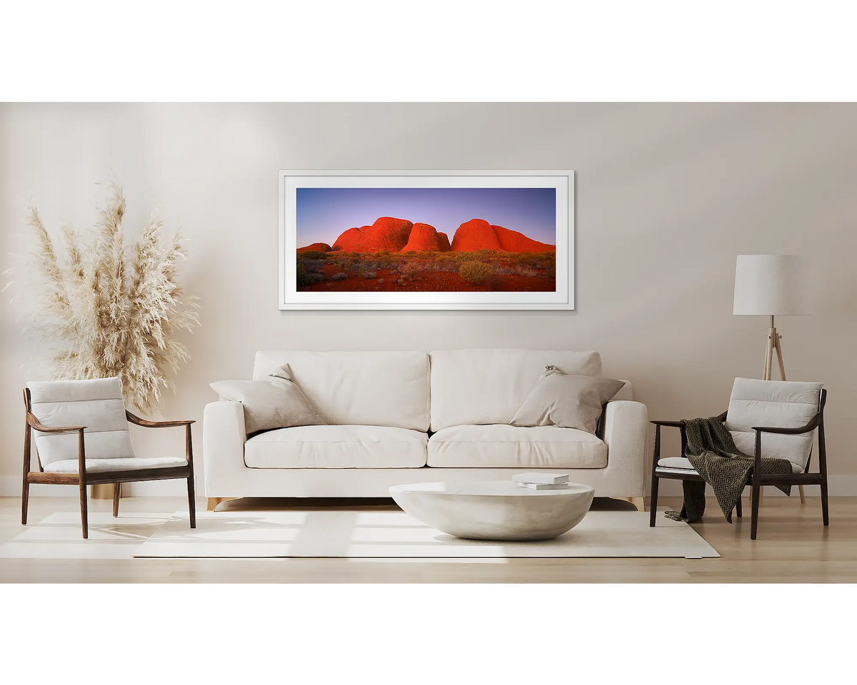 Ancient Land. Outback artwork, in a white frame, above a couch. 