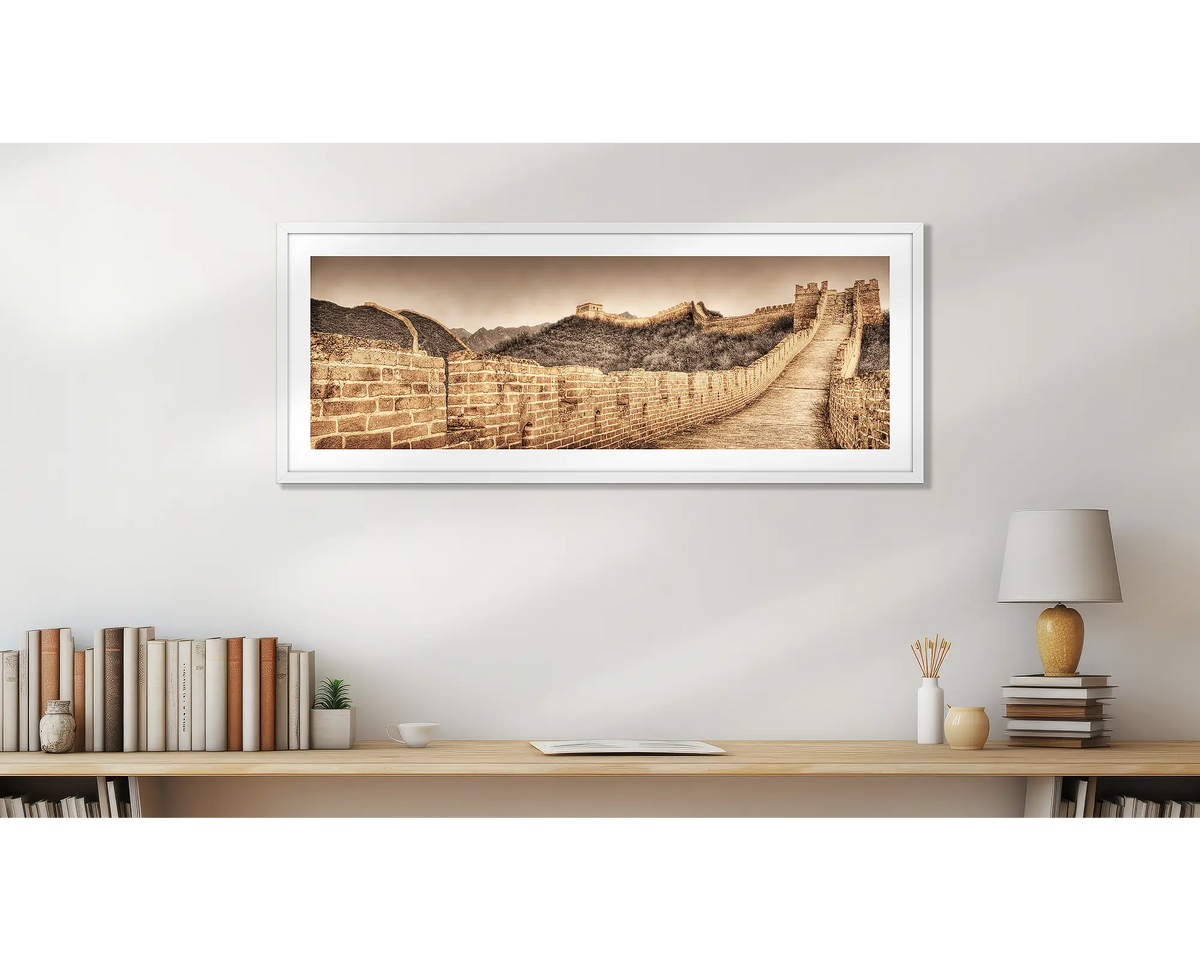 Ancient Wall. Great Wall of China art print, with a white frame, above a desk. 