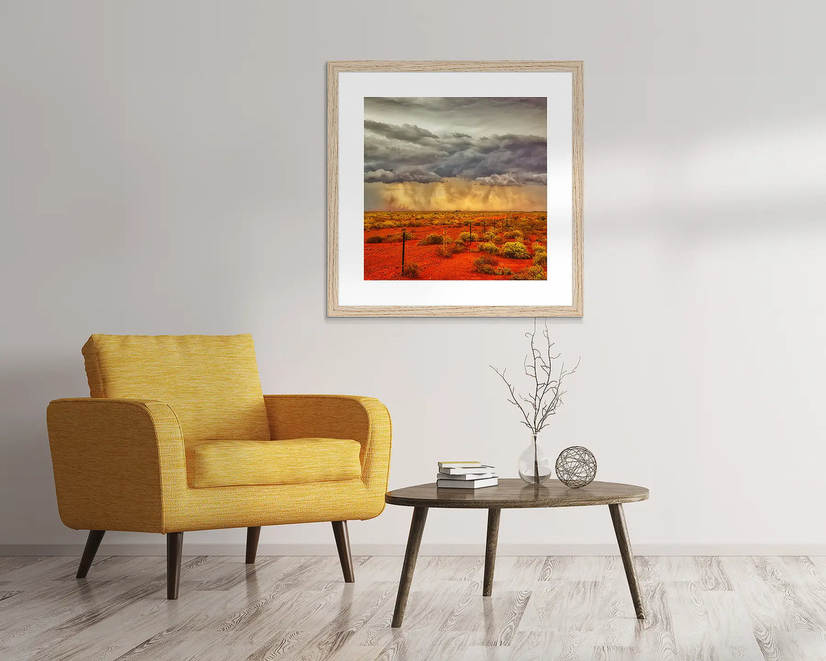 Approaching storm. Outback artwork, in a Tasmanian Oak frame, hanging above a chair.