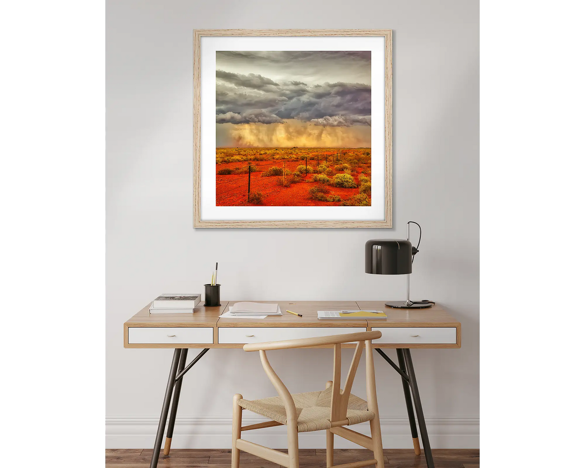 Approaching Storm. Outback artwork, in a timber frame, above a desk. 