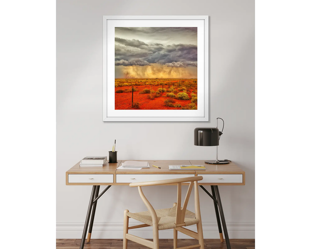 Approaching Storm. Outback artwork in a white frame, above a desk. 