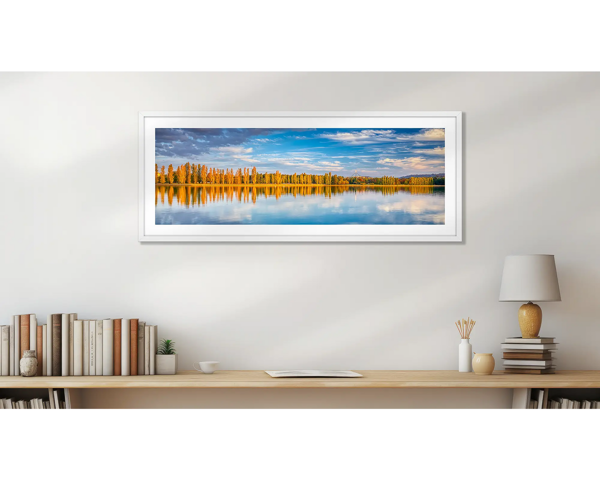 Autumn By The Lake. Wall art print, with a white frame, above a desk. 