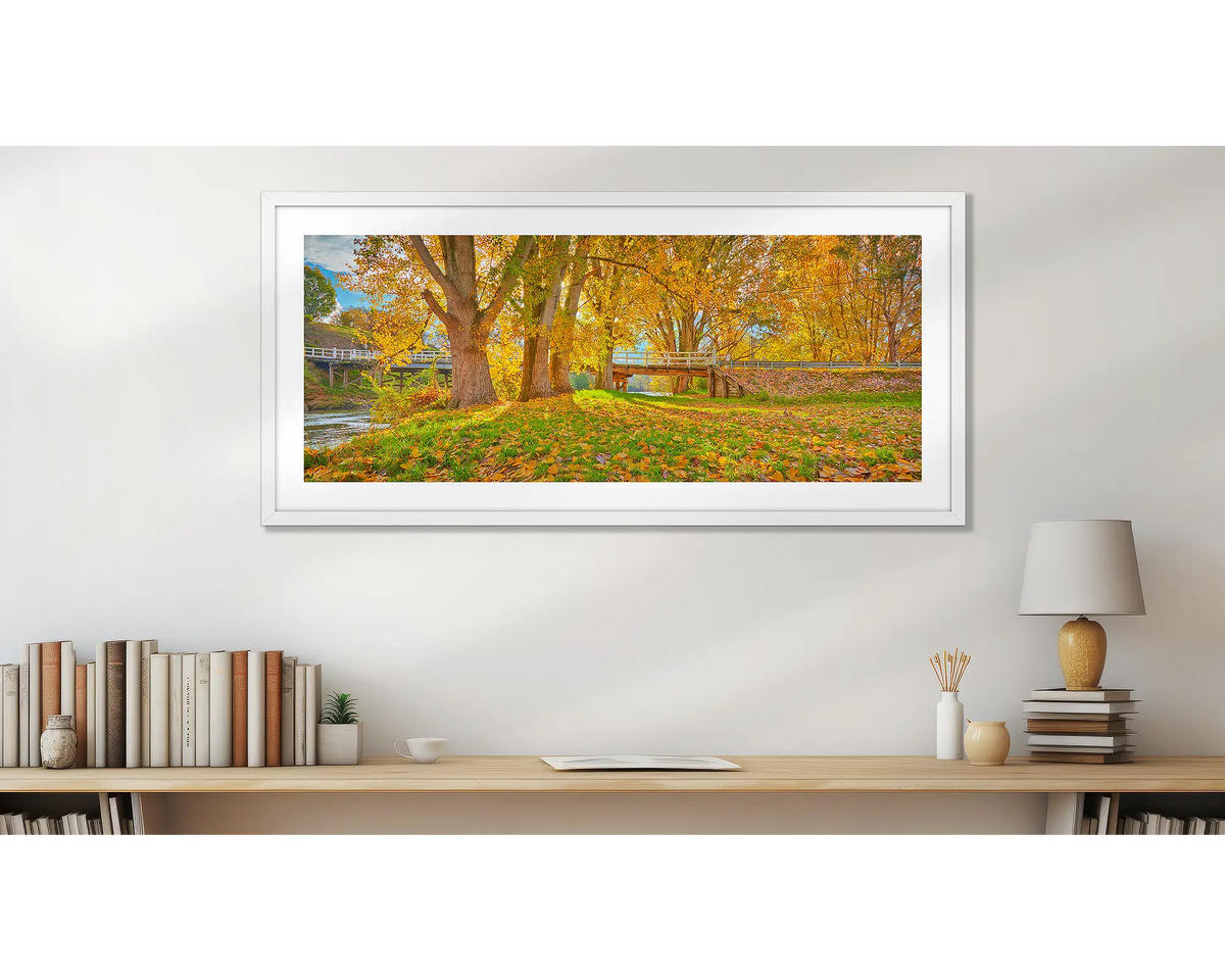 Autumn By The Murray. Wall art print, with a white frame, above a desk. 