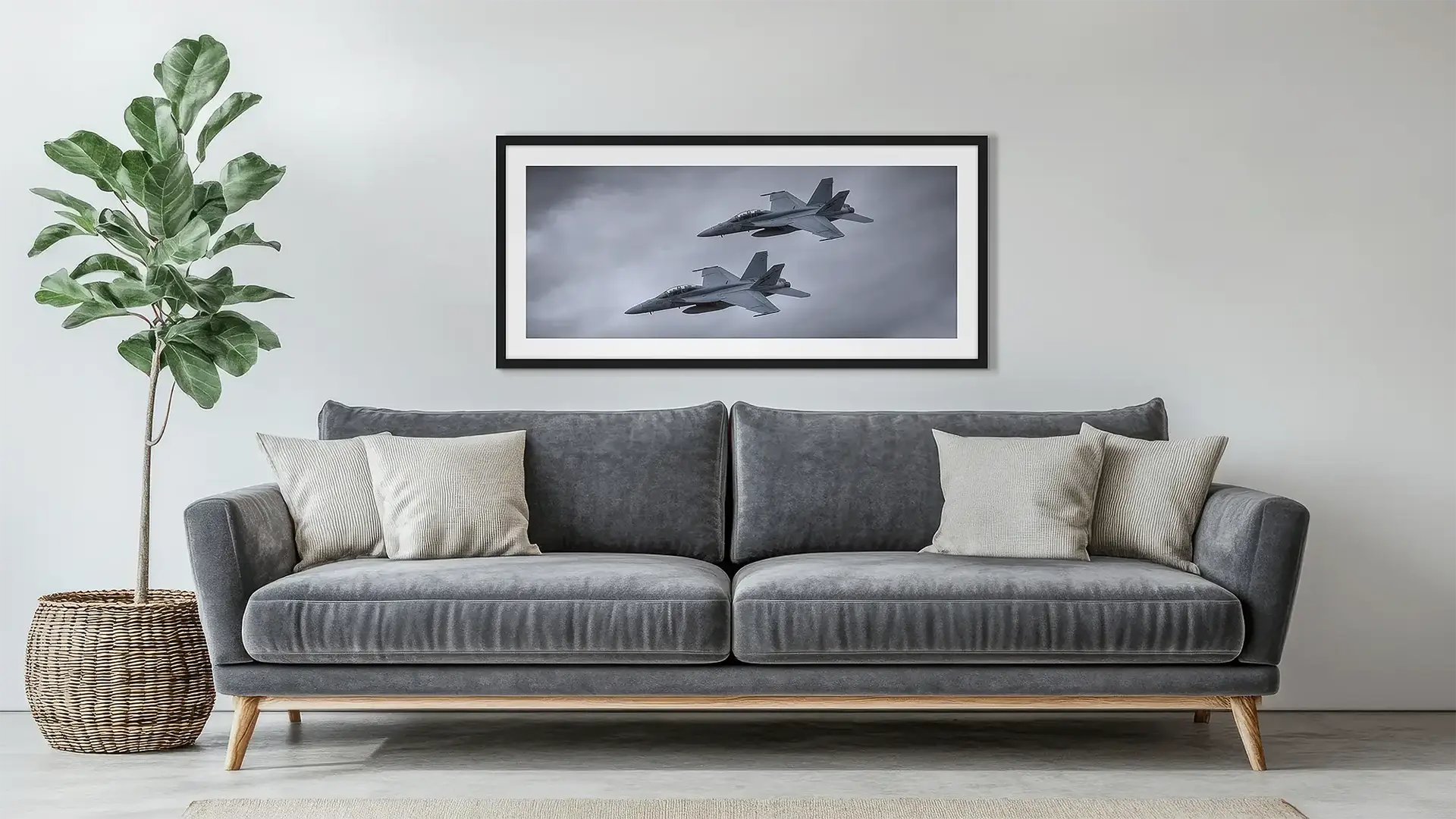 Aviation wall art in black frame hung above a couch.