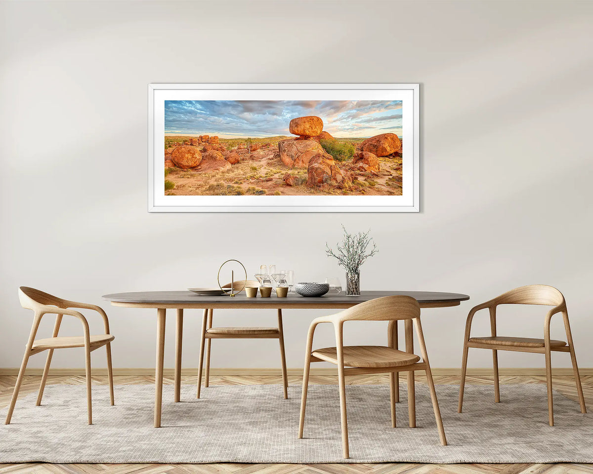 Balanced. Devils Marbles wall art print, with white frame hung above kitchen table.