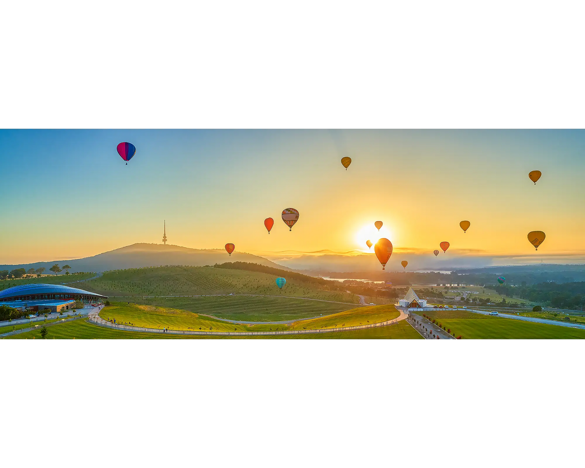 Balloon Sunrise Enlighten Festival hot air balloons at sunrise over National Arboretum in Canberra.