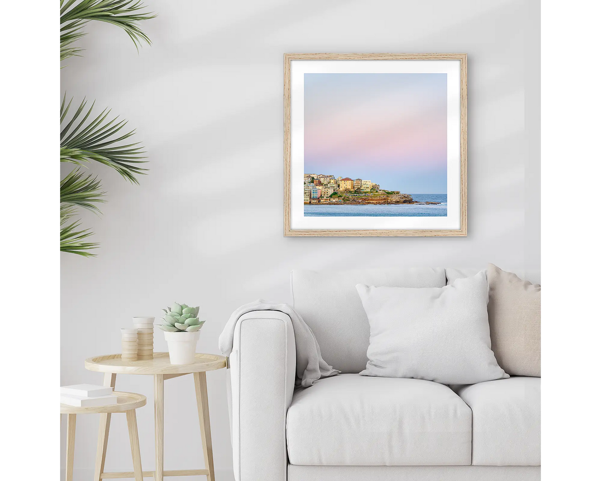 Bondi Heights. Framed Sydney wall art print, with a timber frame, hung above a couch. 