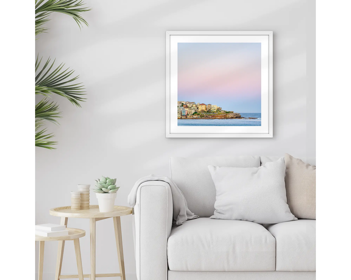 Bondi Heights. Framed Sydney wall art print, with a white frame, hung above a couch. 