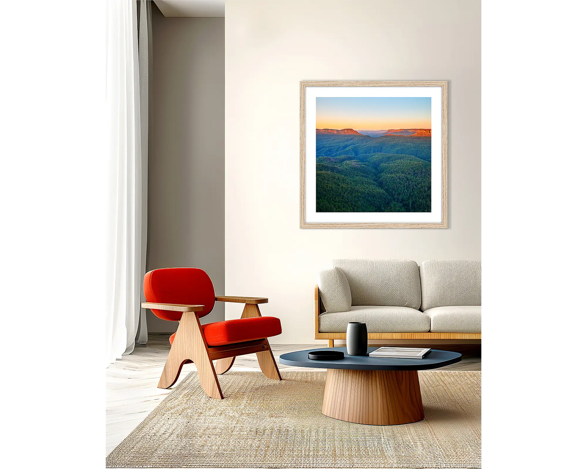 Breaking Dawn. Framed wall art print, in an oak frame, of a Blue Mountains sunrise, hanging in a lounge room.  