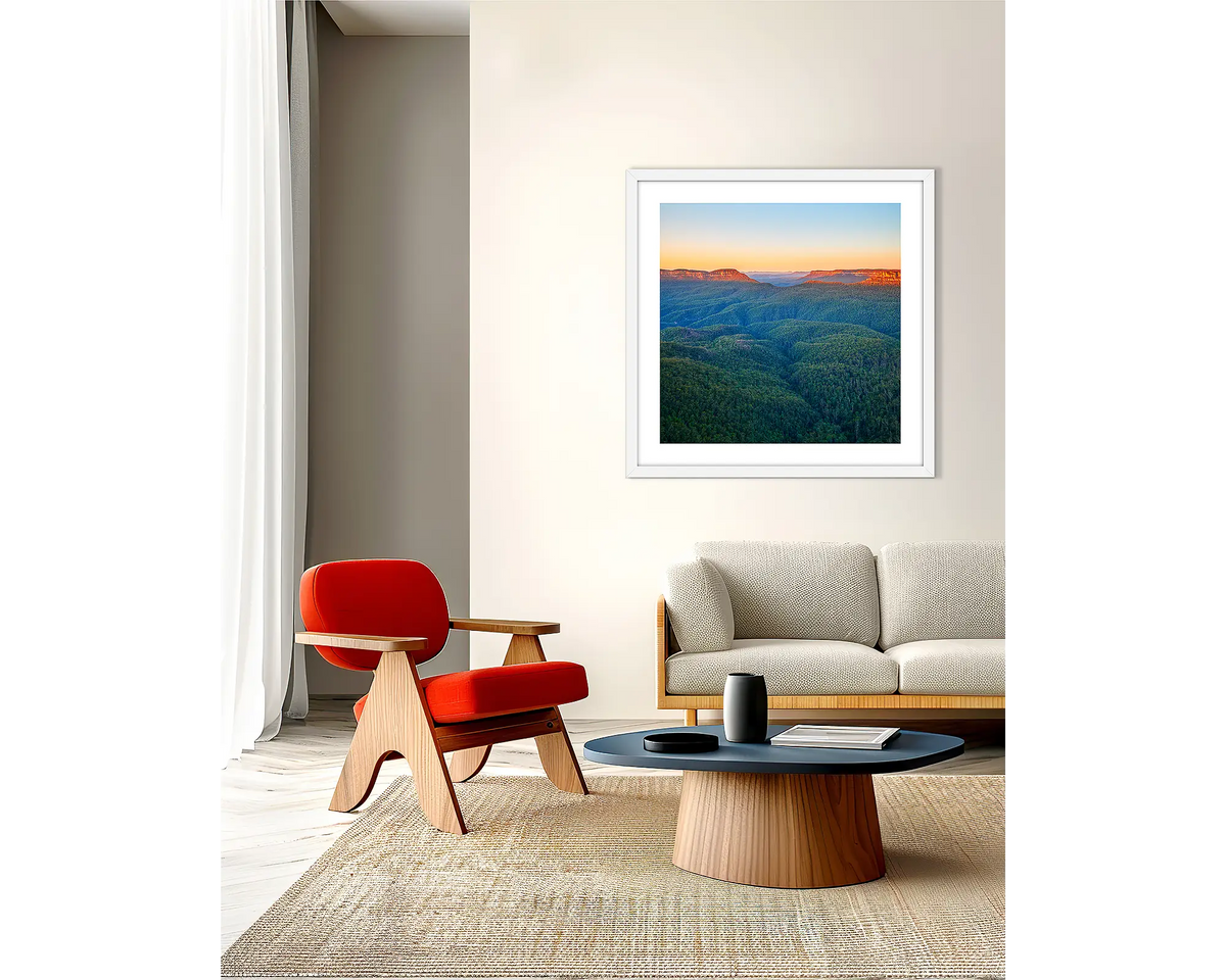 Breaking Dawn. Framed wall art print, in a white frame, of a Blue Mountains sunrise, hanging in a lounge room.  