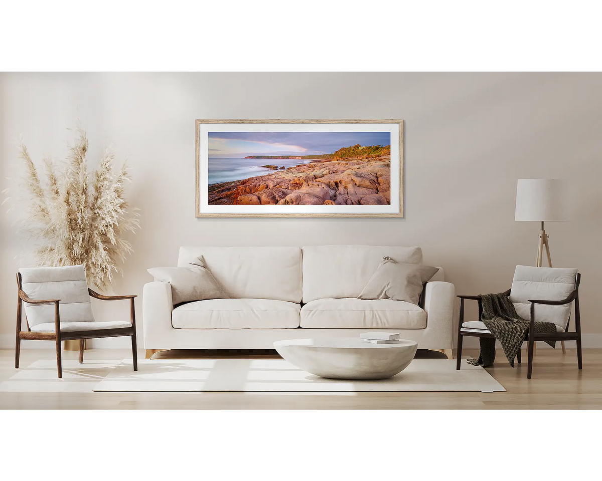 Breaking through. Coastal artwork with a Tassie oak frame, above a couch. 