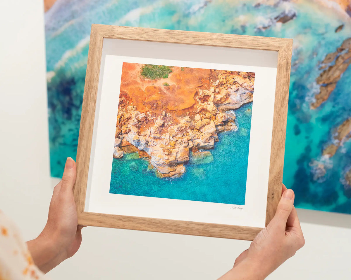 Broome Contrast. Gantheaume Point viewed from above. Australian wall art with wood frame being held.