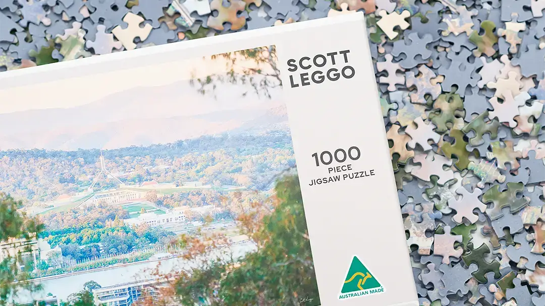 Canberra jigsaw puzzle box with pieces.