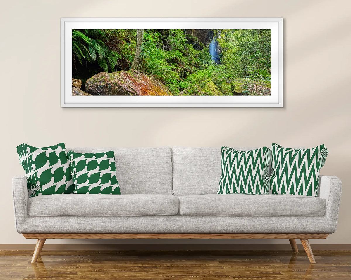 Canyon Escape. Blue Mountains wall art print with white frame hung above couch.