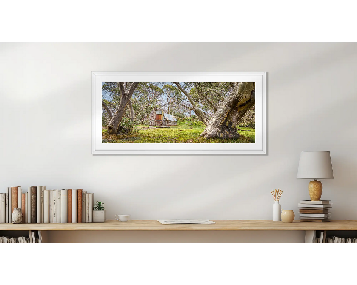 Cattleman&#39;s Rest. Wallace&#39;s hut artwork, in a white frame above a desk. 