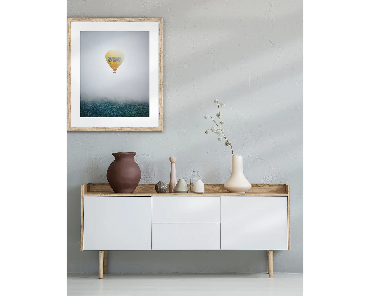 CBR Ballon. Framed Canberra wall art with a Tasmanian Oak frame, above a side table.