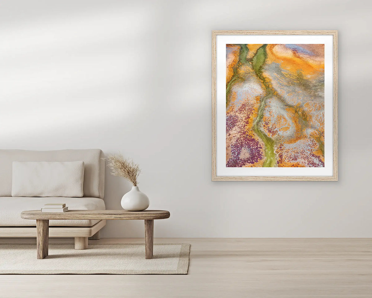 Collision. Abstract aerial wall art print, with a Tassie oak frame, in a living room. 