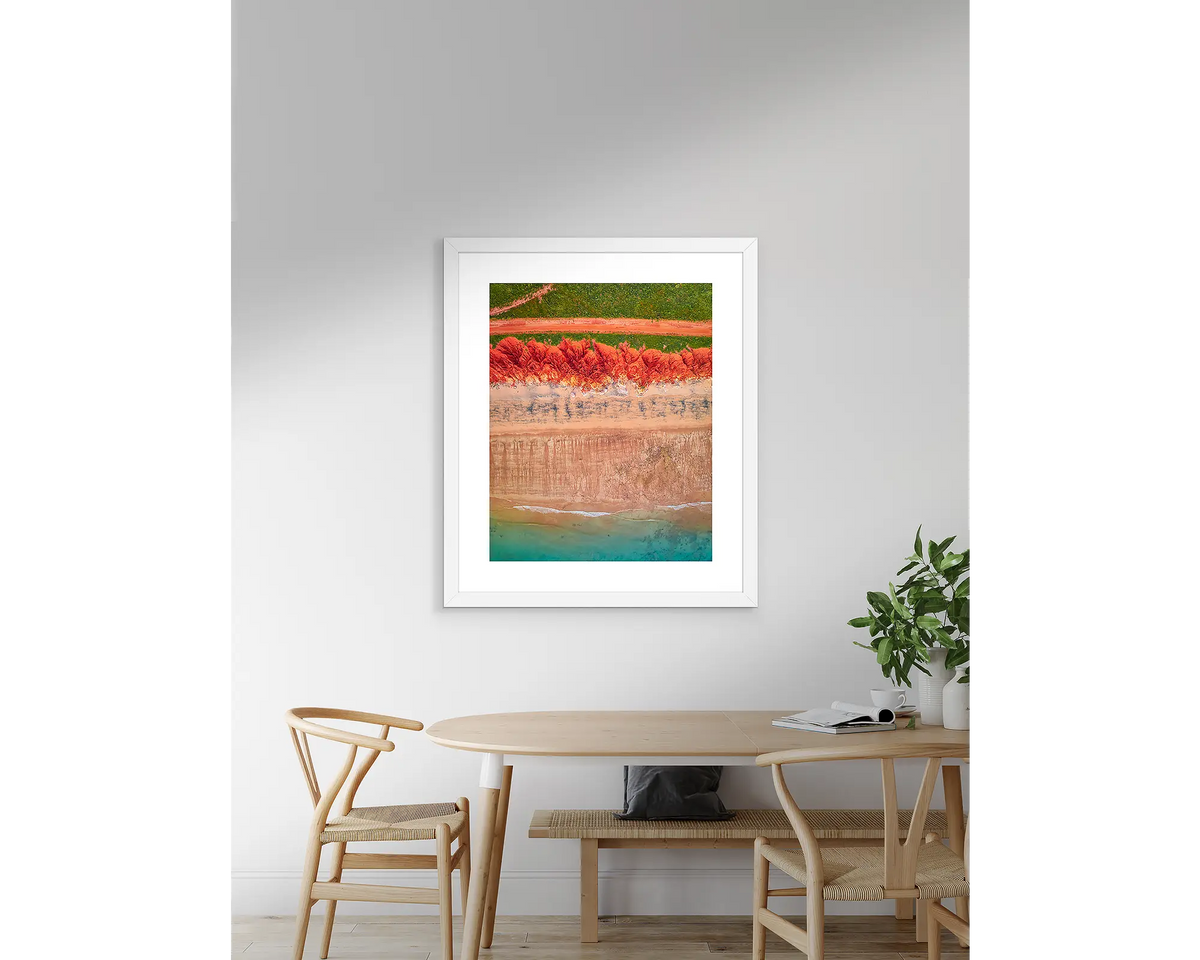 Coloured. Kimberley wall art print with a white frame, hanging on a wall above a table.