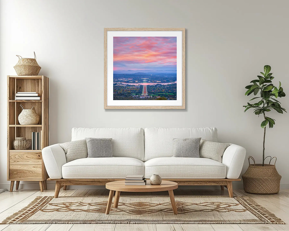 Colours of Canberra. Sunrise wall art print, with a timber frame, above a couch. 