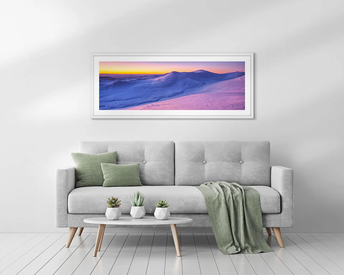 Colours of Winter. Mount Kosciuszko wall art print with white frame hung above couch.