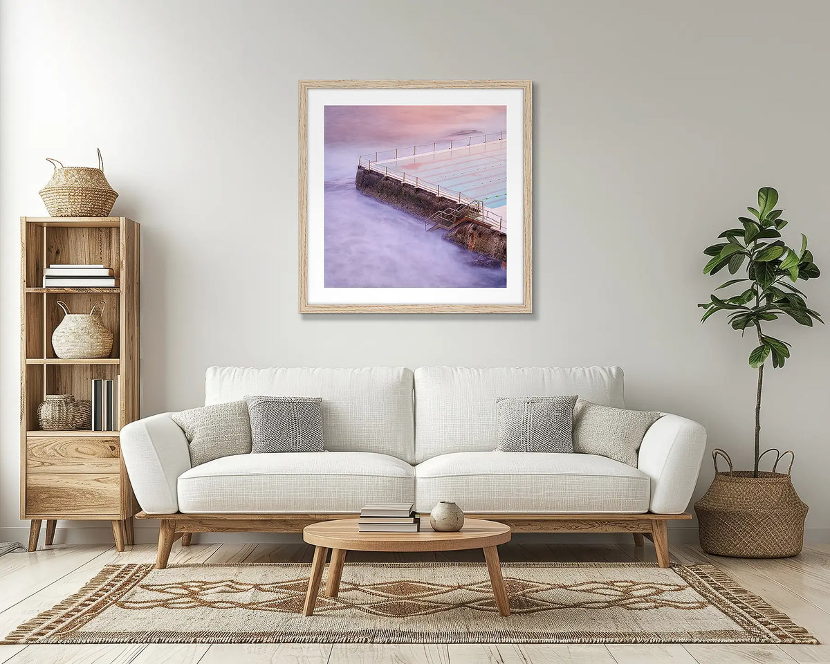 Corner. Bondi icebergs wall art print, with a Tassie oak frame, above a couch. 