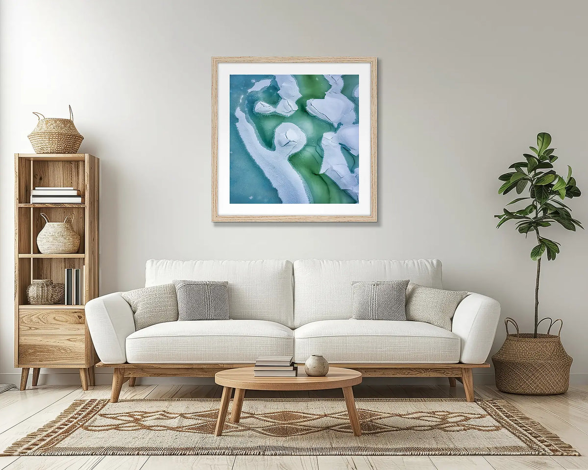 Cracked. Snowy mountains wall art print, with a Tassie oak frame, above a couch. 