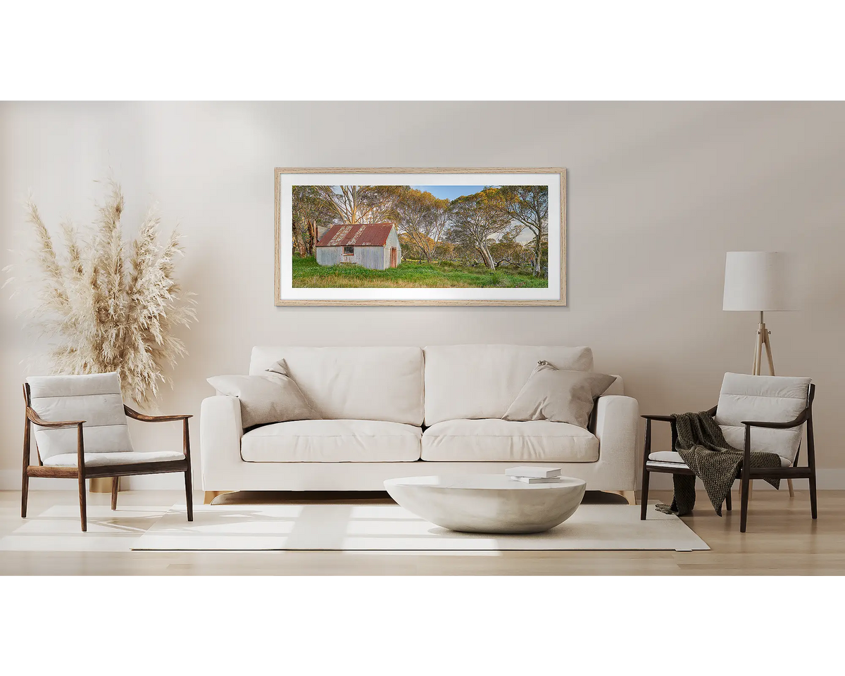 CRB Hut. High country wall art framed in a Tasmanian oak frame, hanging above a couch. 