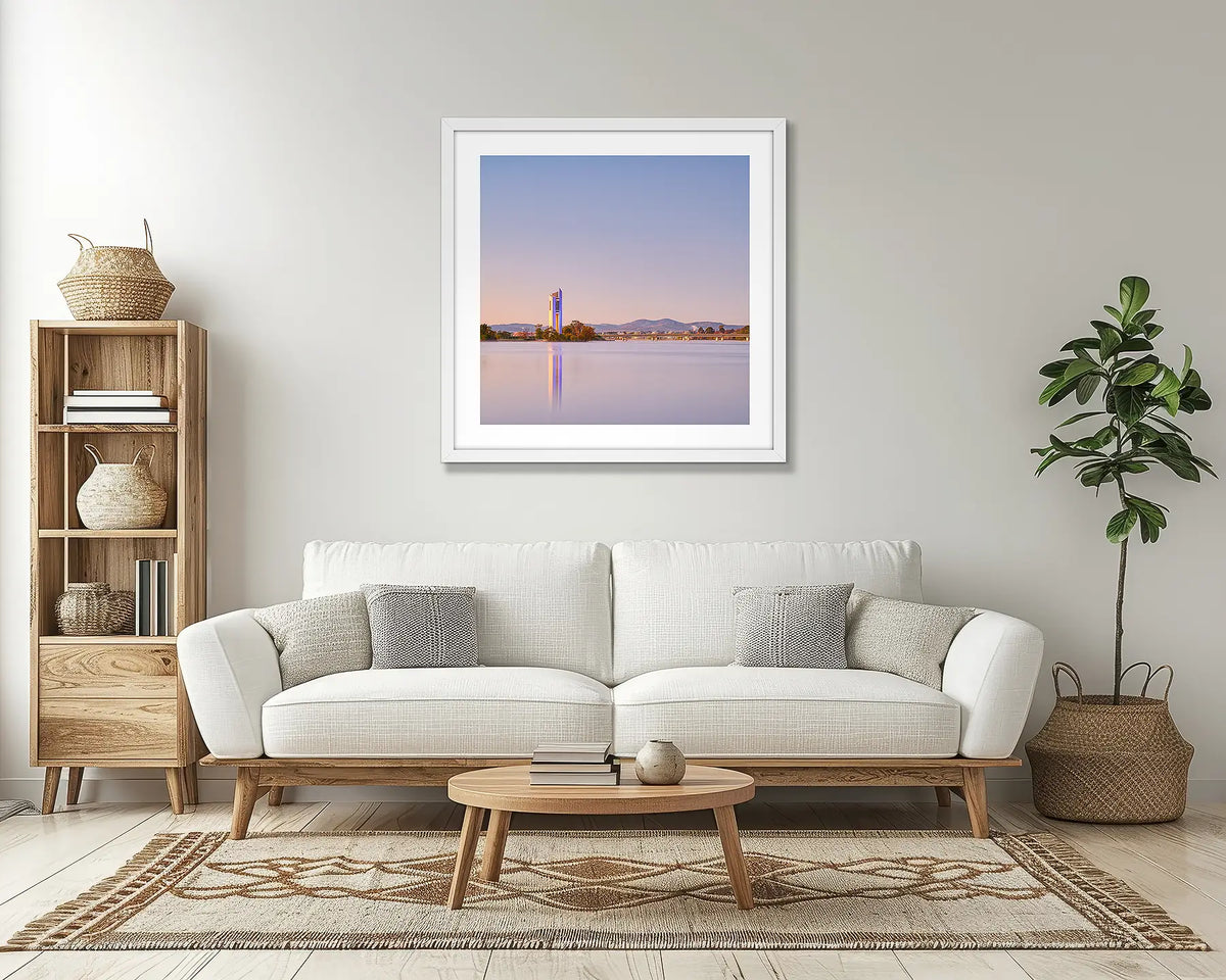 Crisp. Canberra Carillon wall art print, with a white frame, above a couch. 