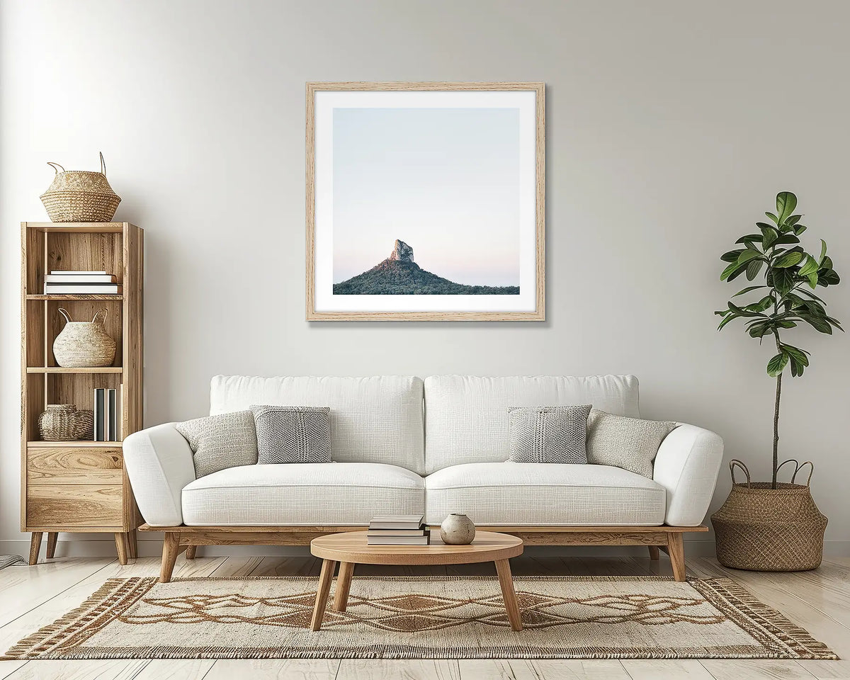 Crookneck. Glasshouse mountains wall art print, with a timber frame, above a couch. 