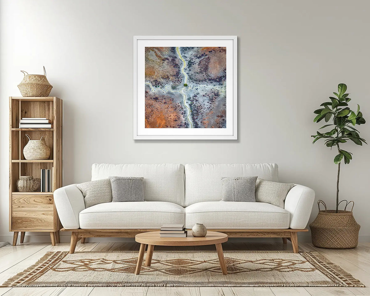 Crossroads. Kimberley abstract wall art print, with a white frame, in a lounge room. 