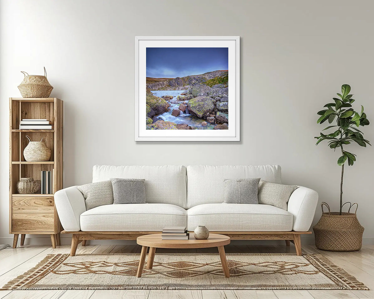 Deep Blue. Snowy mountains wall art print, with a white frame, in a lounge room. 