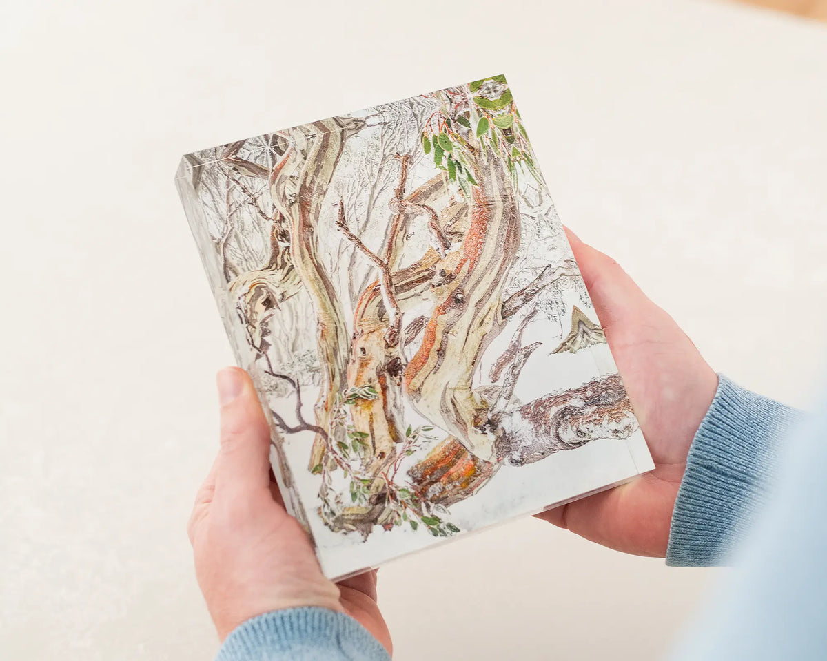 Defiance. Acrylic block of a snow gum in Kosciuszko National Park. Australian artwork being held.