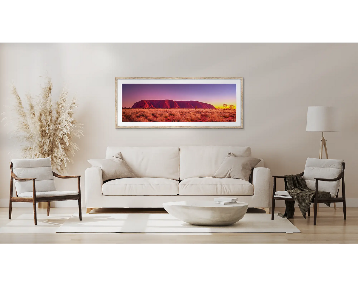 Desert Awakening. Uluru sunrise wall art with a Tasmanian oak frame, above a couch.