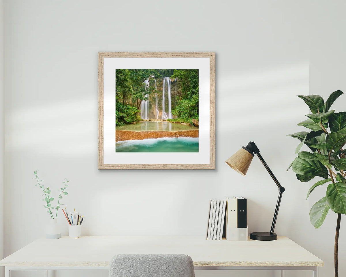 Discovery. Tenaru Falls, waterfall artwork, with a timber frame, on a study wall. 