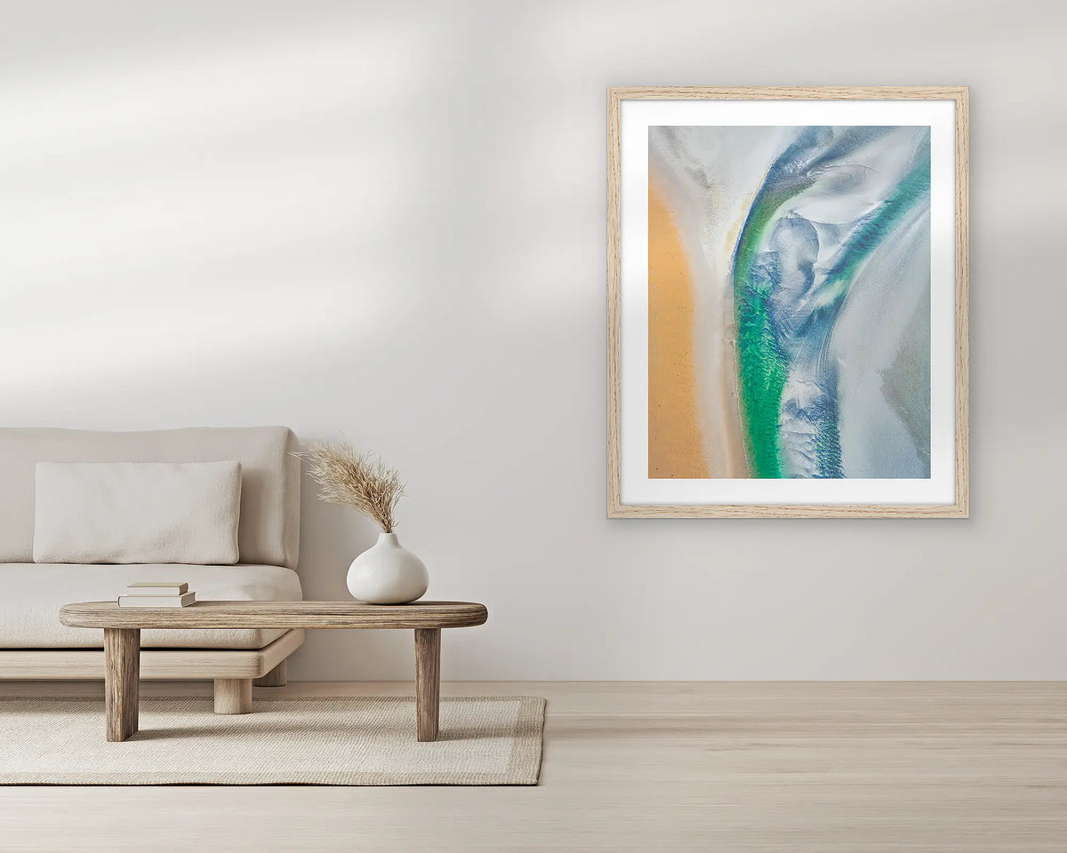 Displacement. Aerial wall art print, with a Tassie oak frame, in a living room. 