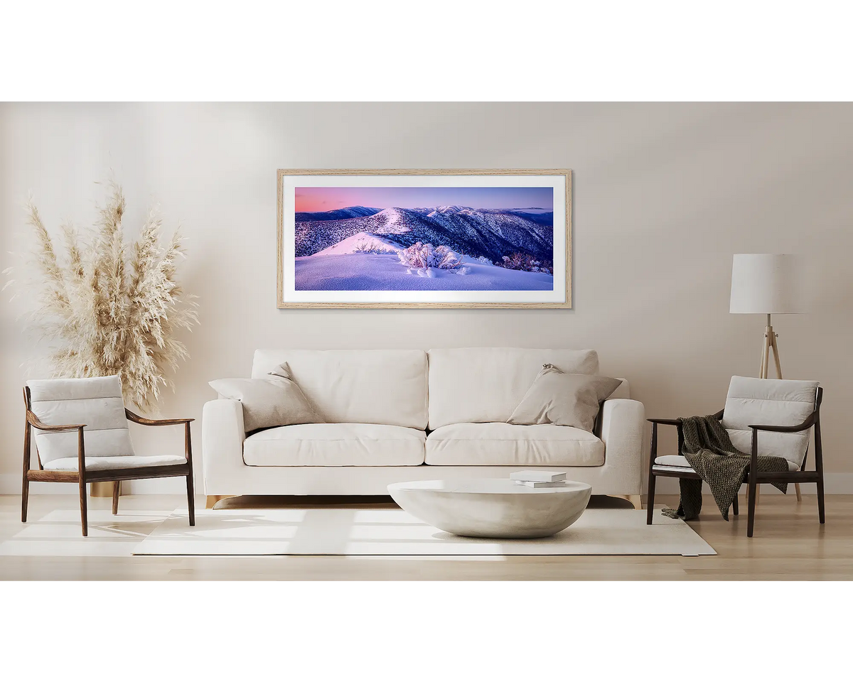 Distance. Winter alpine wall art in a Tassie Oak frame, above a couch. 