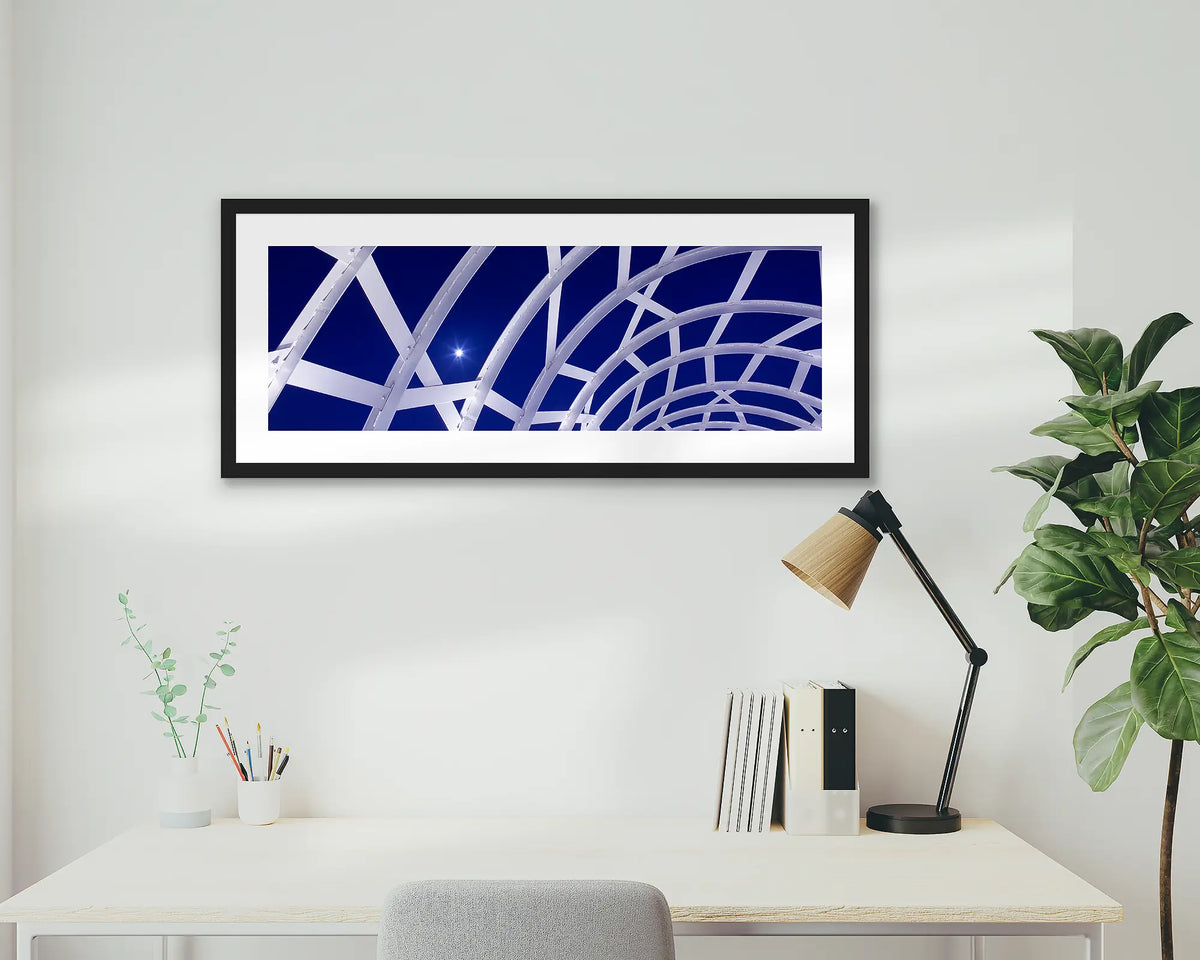 Docklands Moonrise. Webb bridge, Melbourne, framed wall art print with a black frame, above a desk. 