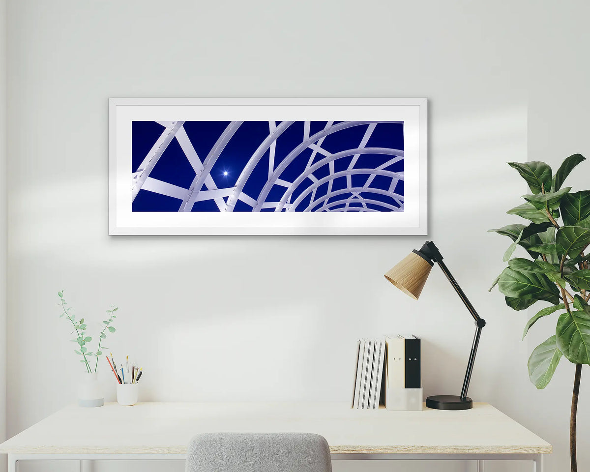 Docklands Moonrise. Webb bridge, Melbourne, framed wall art print with a white frame, above a desk. 