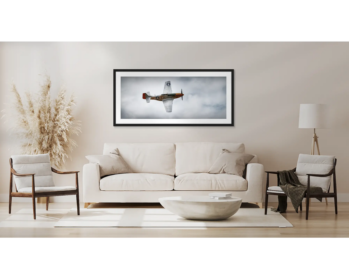 Dove of Peace. P-51 Mustang wall art print, with a black frame, above a couch. 