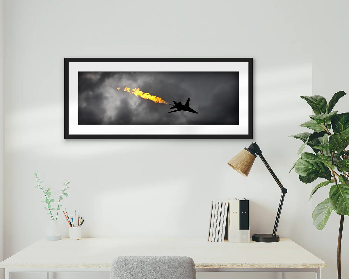 Dump and Burn. Air Force f-111 framed artwork, with a black frame, on a study wall. 