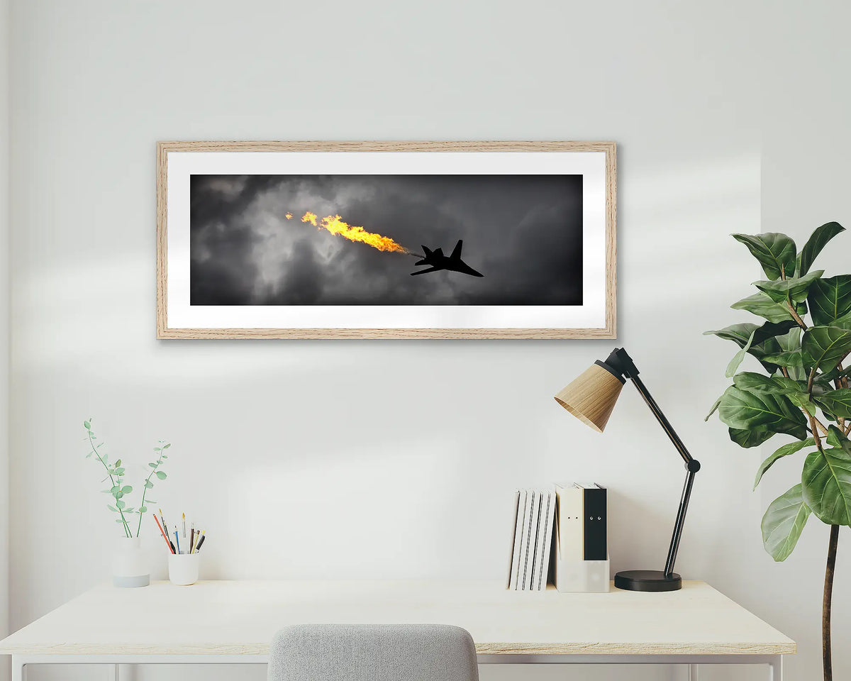 Dump and Burn. Air Force f-111 framed artwork, with a timber frame, on a study wall. 