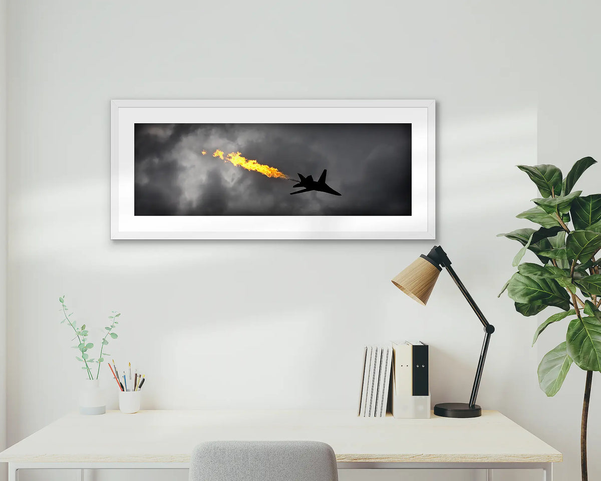 Dump and Burn. Air Force f-111 framed artwork, with a white frame, on a study wall. 