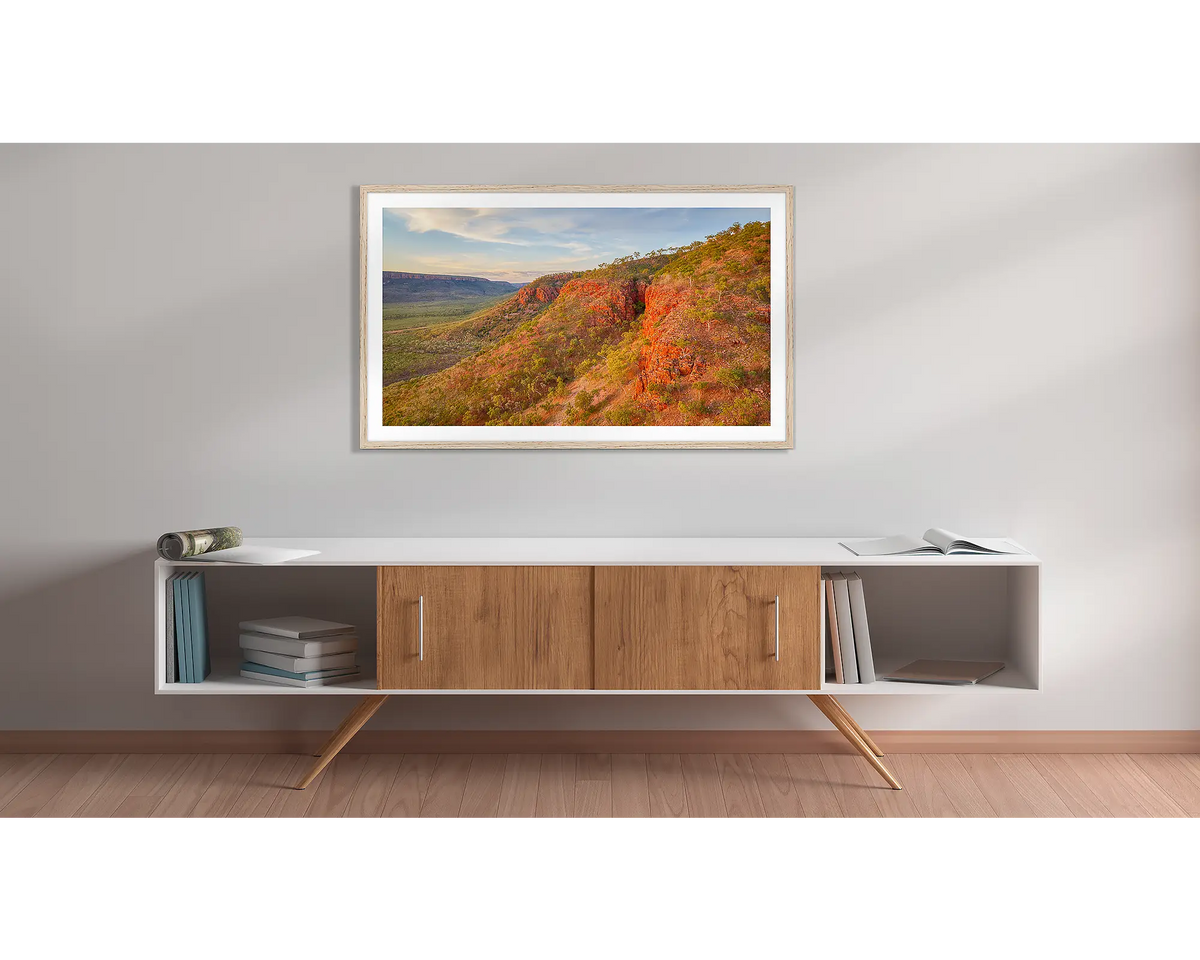 Enduring. Kimberley sunset, framed wall art print with a timber frame, hung above a side table. 