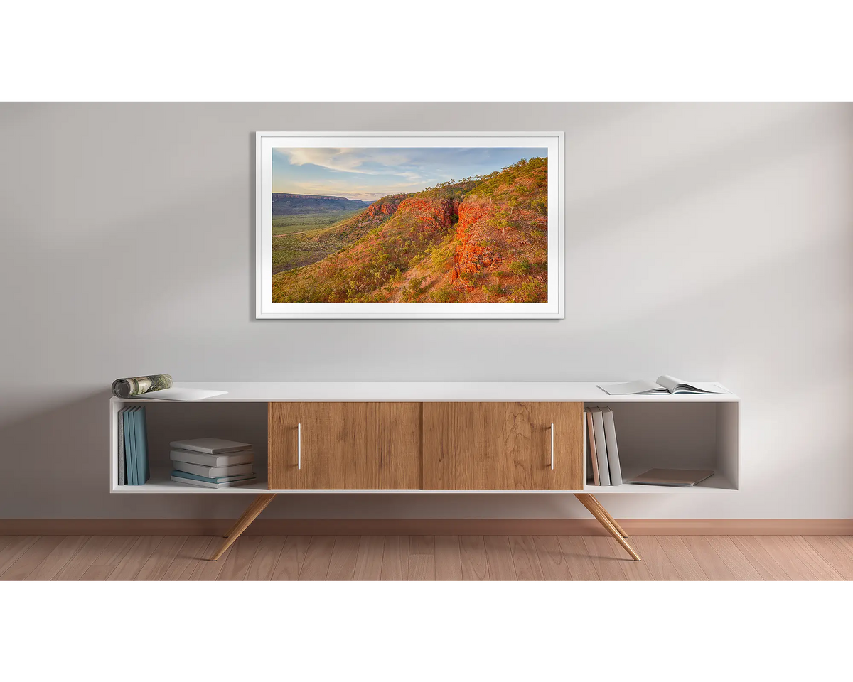 Enduring. Kimberley sunset, framed wall art print with a white frame, hung above a side table. 