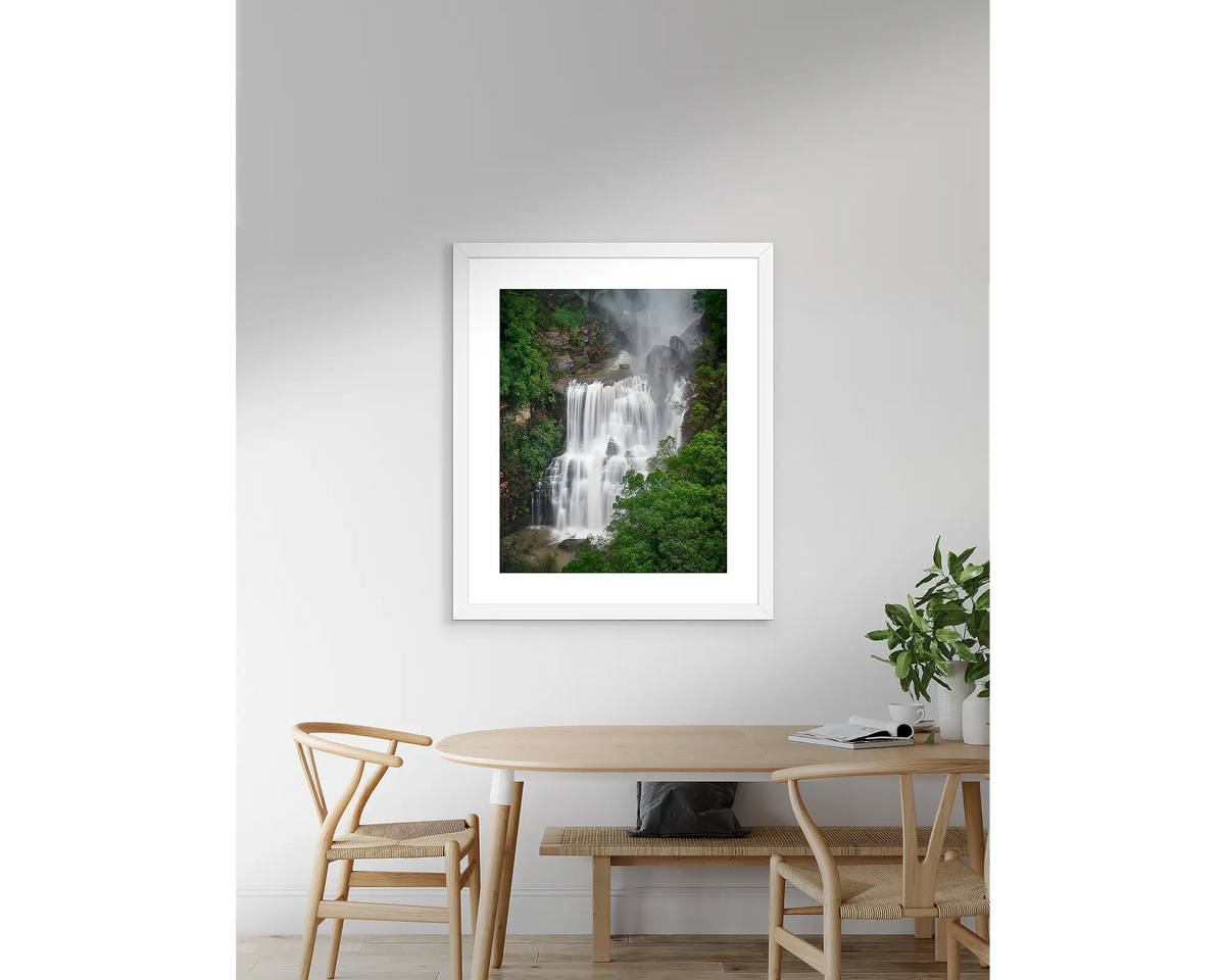 Energy - Waterfall artwork hanging on wall above table.