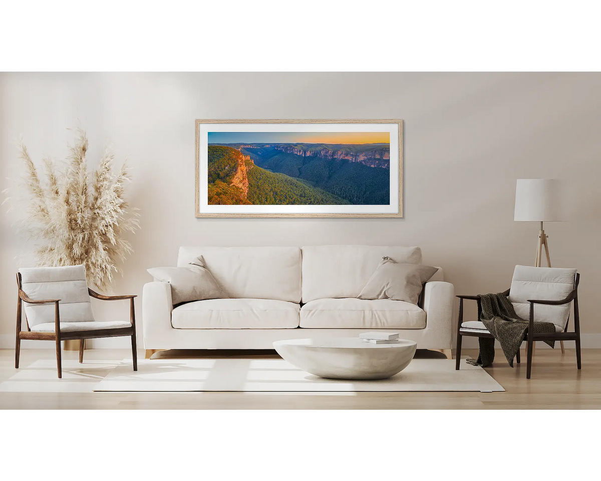 Escape from the City. Blue Mountains wall art print, in a Tassie oak frame, above a couch. 