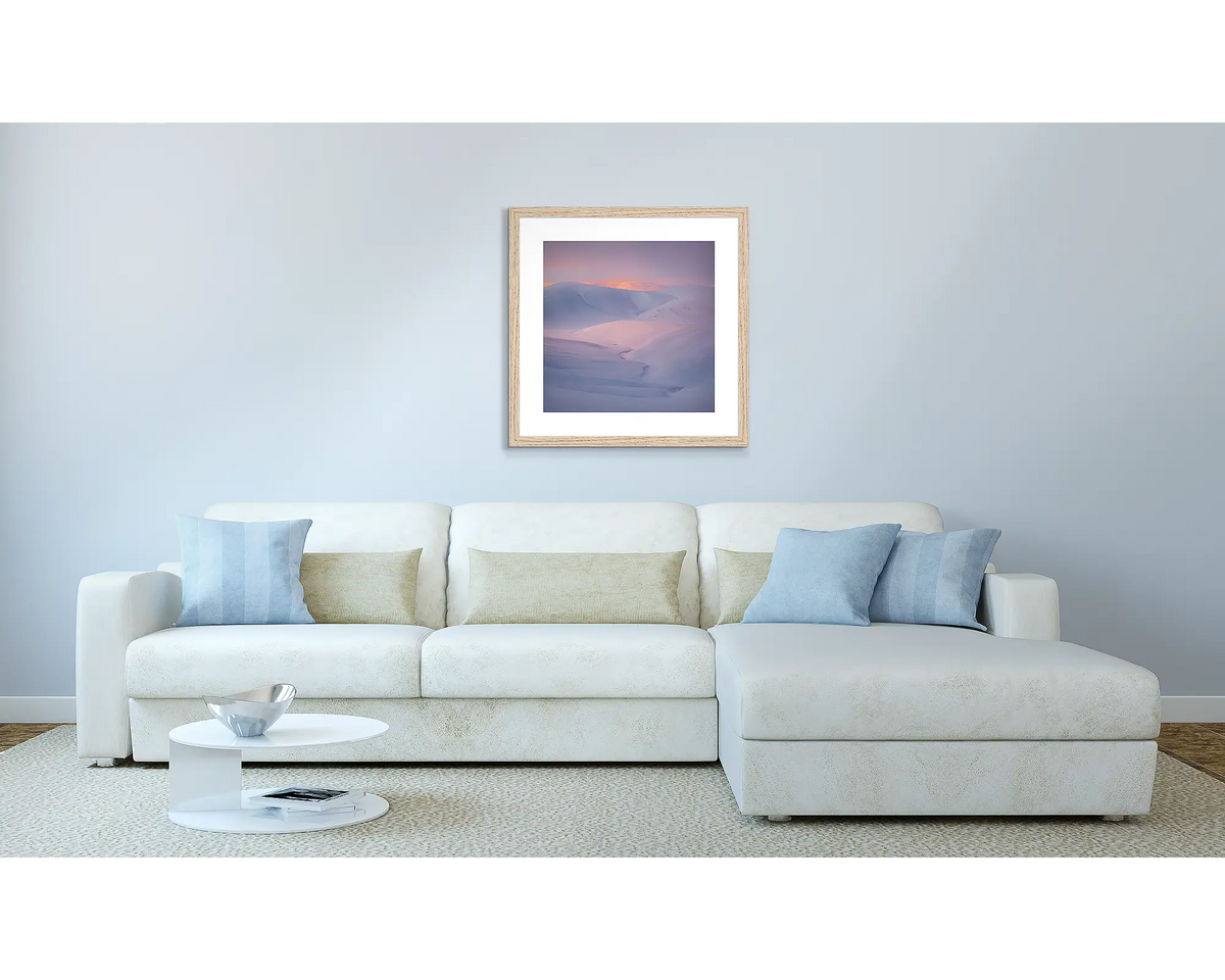 Essence Of The Snowy. Wall art in a Tasmanian oak frame, above a couch.